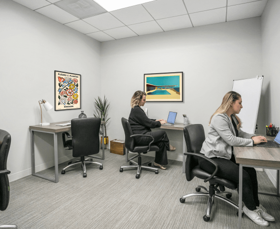 two women working in private office space